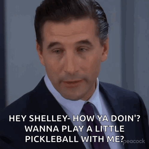 Man In Suit And Tie Asking Shelley To Play Pickleball GIF