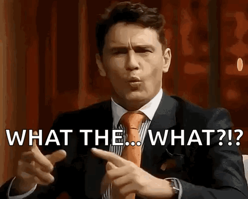 Man in Suit and Tie Asking What the What