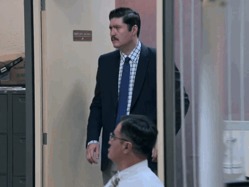 Man in Suit and Tie at Attorney General Door