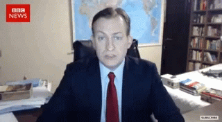 Man in Suit and Tie at BBC News Screen