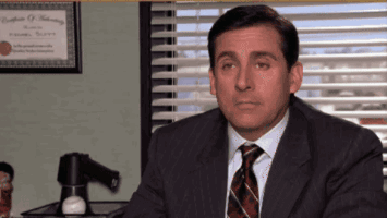 Man in Suit and Tie at Desk by Window