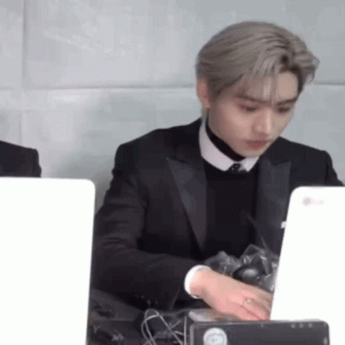 Man in Suit and Tie at Desk with Laptop