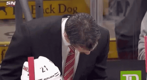 Man in Suit and Tie at Flick Dog Sign