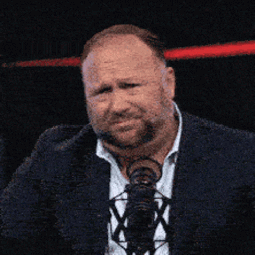 Man in Suit and Tie at M Microphone