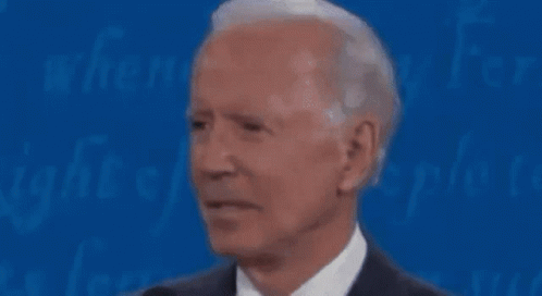 Man in Suit and Tie at Microphone