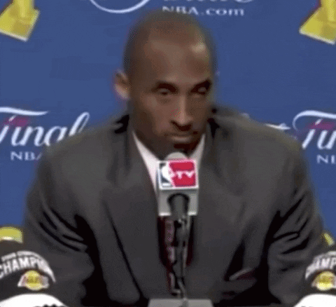 Man in Suit and Tie at Microphone