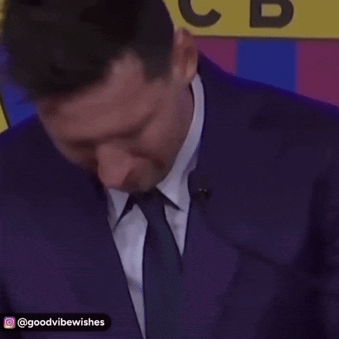 Man in Suit and Tie at Microphone