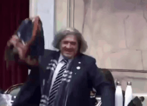 Man In Suit And Tie At Microphone GIF