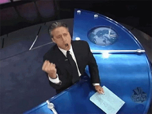 Man in Suit and Tie at NBC Comedy Central News Desk
