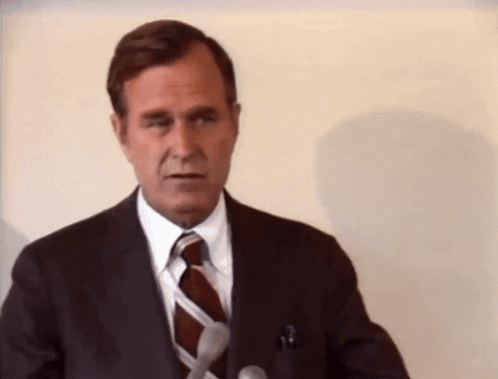Man in Suit and Tie at Podium
