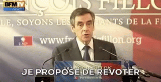 Man In Suit And Tie At Podium Je Propose De Revoter GIF