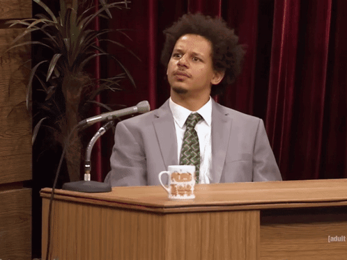 Man In Suit And Tie At Podium With Adult Cup GIF