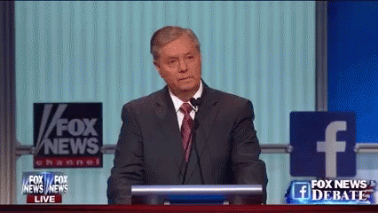 Man In Suit And Tie At Podium With Fox News Sign GIF