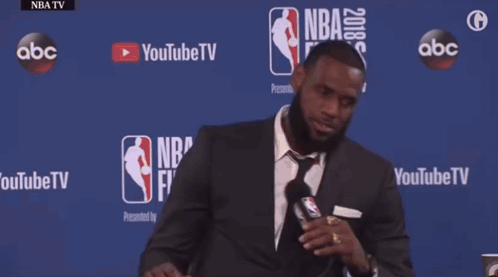 Man in Suit and Tie at Table With NBA Finals