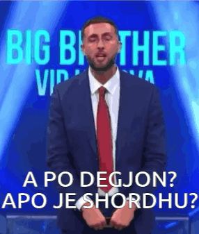 Man in Suit and Tie Before Big Brother VIP Sign