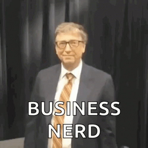 Man in Suit and Tie Before Black Curtain