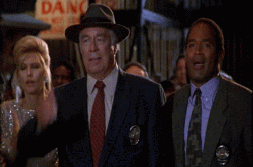 Man In Suit And Tie Before Dang Sign GIF