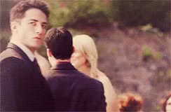 Man in Suit and Tie before Woman in White