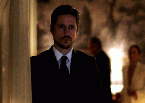 Man In Suit And Tie Beside Wall GIF