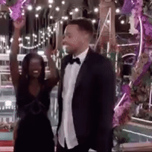 Man In Suit And Tie Beside Woman In Dress GIF