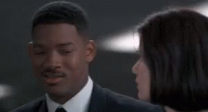 Man in Suit and Tie Beside Woman in White Shirt