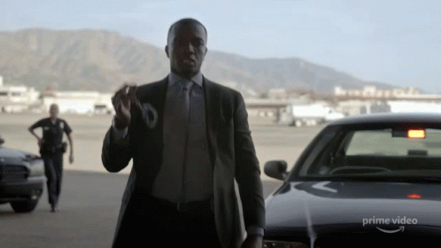 Man in Suit and Tie by Prime Video Car