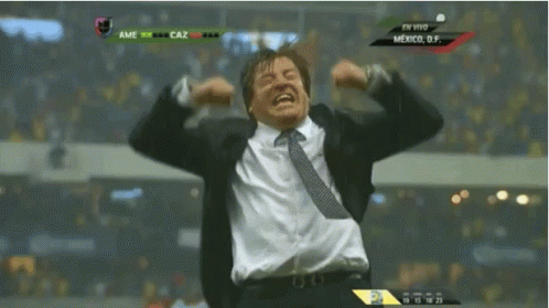 Man in Suit and Tie Celebrating at Mexico Scoreboard