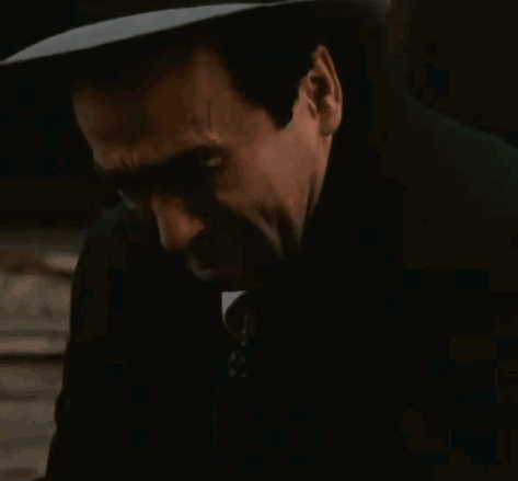 Man in Suit and Tie Covering Ears