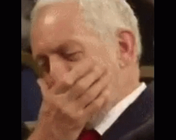 Man In Suit And Tie Covering Mouth GIF