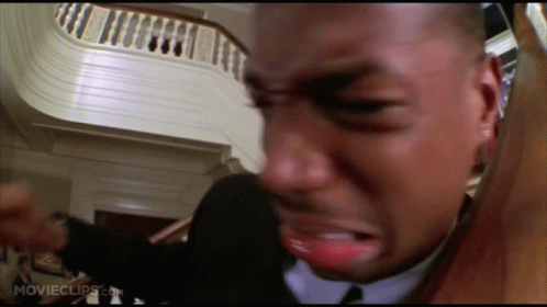 Man in Suit and Tie Crying by Stairs