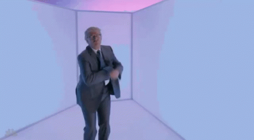 Man in Suit and Tie Dancing in Cube