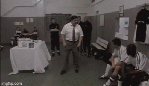 Man in Suit and Tie Dancing in Locker Room