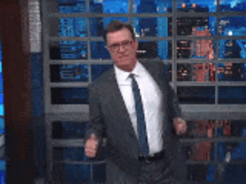Man in Suit and Tie Dancing on Stage
