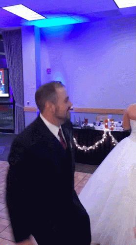 Man In Suit And Tie Dancing With Bride GIF