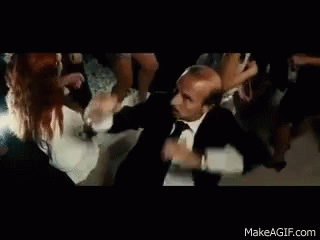 Man in Suit and Tie Dancing with Group