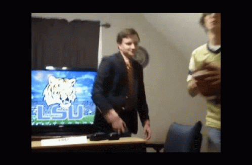 Man in Suit and Tie Dancing with LSU