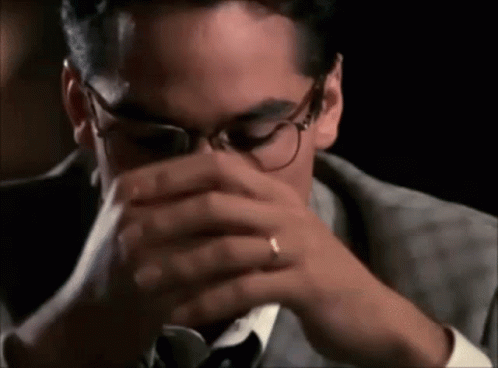 Man in Suit and Tie Drinking From Glass