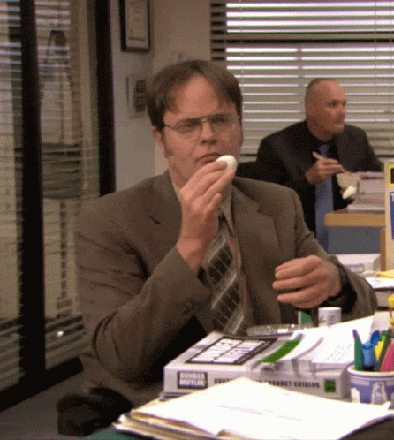 Man in Suit and Tie Eating Donut From Donut King Box