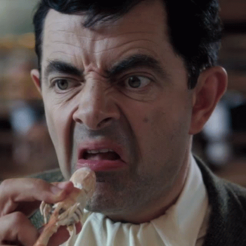 Man In Suit And Tie Eating Meat GIF