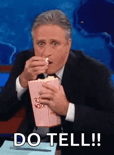 Man in Suit and Tie Eating Popcorn
