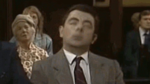 Man In Suit And Tie Eyes Closed Crowd GIF