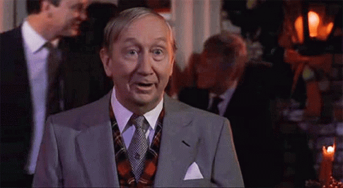 Man in Suit and Tie Facing Group