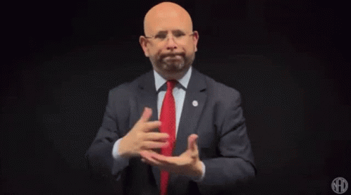 Man in Suit and Tie Gesturing