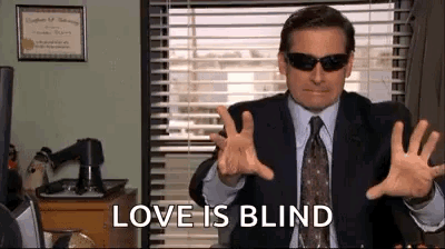 Man in Suit and Tie Gesturing With Sunglasses