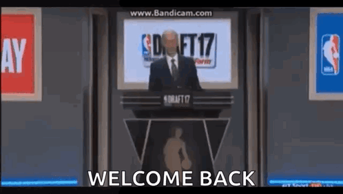 Man In Suit And Tie Gives Speech At Podium Welcome Back GIF