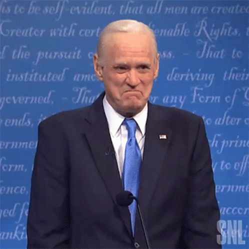 Man in Suit and Tie Giving Speech at Podium