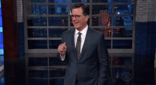 Man in Suit and Tie Giving Thumbs Up