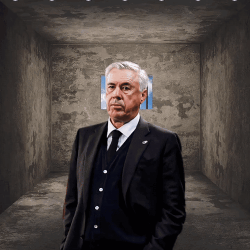 Man in Suit and Tie Hands in Pockets Dark Room