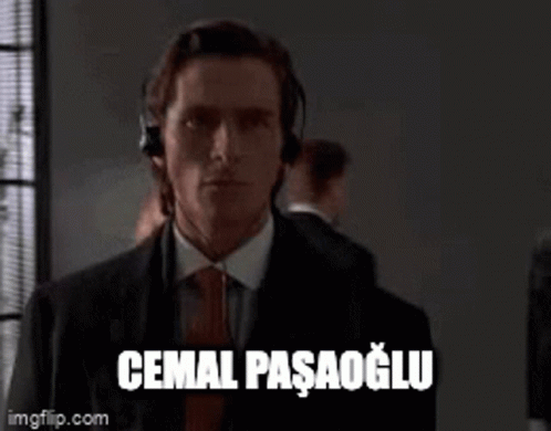 Man in Suit and Tie Headphones Saying Cemal Pasagolu