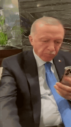 Man in Suit and Tie Holding Cell Phone